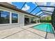The pool and spa create an inviting outdoor space with a covered patio and lush landscaping at 3999 Burdick Loop, Odessa, FL 33556