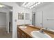 Dual sink bathroom with wood cabinets, modern fixtures, and a large mirror at 441 75Th N Ave, St Petersburg, FL 33702