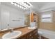 Spacious bathroom featuring double sinks, updated fixtures, and a shower-tub combination at 441 75Th N Ave, St Petersburg, FL 33702