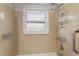 Shower area with a shower caddy and window for natural light and tan colored tiles at 441 75Th N Ave, St Petersburg, FL 33702