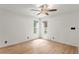 Bright bedroom featuring wood-look floors, two windows providing natural light, and a ceiling fan at 441 75Th N Ave, St Petersburg, FL 33702