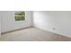 Bedroom has a window letting in natural light, carpeted floors, and white walls at 441 75Th N Ave, St Petersburg, FL 33702