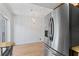 Bright dining room with wood floors and a decorative chandelier with stainless refrigerator at 441 75Th N Ave, St Petersburg, FL 33702