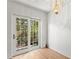 Bright dining room with wood floors and a decorative chandelier with view of foliage outside at 441 75Th N Ave, St Petersburg, FL 33702