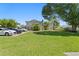 Exterior view highlighting lush greenery, ample parking and a well-maintained lawn under the blue sky at 441 75Th N Ave, St Petersburg, FL 33702