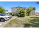 Charming two-story exterior with lush greenery, ample parking, and a well-maintained lawn at 441 75Th N Ave, St Petersburg, FL 33702