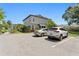 Exterior view of the home with a parked white SUV and gray sedan in its spacious parking area at 441 75Th N Ave, St Petersburg, FL 33702