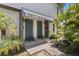 Inviting front doors with a striped awning and landscaped walkway create a warm welcome at 441 75Th N Ave, St Petersburg, FL 33702