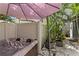 Hot tub area with shade umbrella and tropical plants at 441 75Th N Ave, St Petersburg, FL 33702