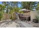 Backyard featuring a private hot tub surrounded by tropical greenery and pavers at 441 75Th N Ave, St Petersburg, FL 33702