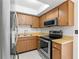 Efficient kitchen with stainless steel appliances, wood cabinetry, and bright countertops at 441 75Th N Ave, St Petersburg, FL 33702