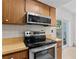 Modern kitchen features stainless steel appliances, laminate cabinets and countertops, and access to the backyard at 441 75Th N Ave, St Petersburg, FL 33702