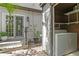 Enclosed laundry area featuring a washer and dryer with outdoor access at 441 75Th N Ave, St Petersburg, FL 33702