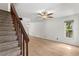 Bright living room with a ceiling fan, and the staircase is on the left side, with wood-look floors and ample natural light at 441 75Th N Ave, St Petersburg, FL 33702