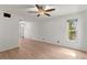 Open living room featuring wood-look floors, a ceiling fan, and a large window providing natural light at 441 75Th N Ave, St Petersburg, FL 33702