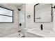 Updated bathroom features modern vanity, new toilet, and white marble-look tile shower at 4461 Shore Acres Ne Blvd, St Petersburg, FL 33703