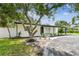 Landscaped front with mature trees provides shade and enhances curb appeal for this lovely property at 4461 Shore Acres Ne Blvd, St Petersburg, FL 33703