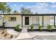 Charming single-story home featuring a manicured yard with tasteful landscaping and modern black and white accents at 4461 Shore Acres Ne Blvd, St Petersburg, FL 33703