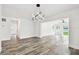Bright living room features gray wood-look floors, white walls, and modern lighting at 4461 Shore Acres Ne Blvd, St Petersburg, FL 33703