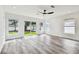 Bright living room features large sliding glass doors, white walls, and ceiling fan at 4461 Shore Acres Ne Blvd, St Petersburg, FL 33703