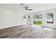 Bright living room features large sliding glass doors, white walls, and ceiling fan at 4461 Shore Acres Ne Blvd, St Petersburg, FL 33703
