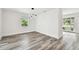 Bright living room features gray wood-look floors, white walls, and modern lighting at 4461 Shore Acres Ne Blvd, St Petersburg, FL 33703