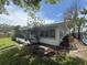 View of the backyard, highlighting the screened enclosure and exterior of the home at 4641 Carson Ne St, St Petersburg, FL 33703