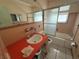 Retro bathroom featuring a shower with glass doors, tile surround, and a contrasting vanity at 4641 Carson Ne St, St Petersburg, FL 33703