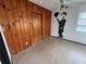 Bedroom with unique wall art, wood paneling, and neutral-toned flooring for a distinctive style at 4641 Carson Ne St, St Petersburg, FL 33703
