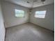 Bedroom with ample natural light from two windows and a neutral color scheme, offering a serene space at 4641 Carson Ne St, St Petersburg, FL 33703