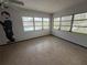 Bedroom with ample natural light from multiple windows, complete with unique wall decor at 4641 Carson Ne St, St Petersburg, FL 33703