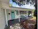 Front porch view featuring a seating area, door, and well-maintained landscaping at 4641 Carson Ne St, St Petersburg, FL 33703