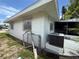 An exterior view of the house featuring a modern AC unit, fence, and screened porch at 4641 Carson Ne St, St Petersburg, FL 33703