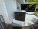 Close up of AC unit and screened lanai on house exterior with palm trees for privacy at 4641 Carson Ne St, St Petersburg, FL 33703