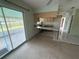 Kitchen with a breakfast bar, and a sliding glass door to a covered patio overlooking the backyard at 4641 Carson Ne St, St Petersburg, FL 33703