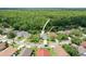 Aerial view of the property in a residential neighborhood with mature trees and landscaping at 4948 Ridgemoor Cir, Palm Harbor, FL 34685