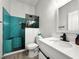 This updated bathroom features a modern glass enclosed shower and white vanity with black hardware at 4948 Ridgemoor Cir, Palm Harbor, FL 34685