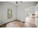 This bedroom features wood floors and a view leading into another room with tile flooring at 4948 Ridgemoor Cir, Palm Harbor, FL 34685