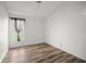 Bright bedroom featuring wood-look floors and a window, offering comfort and style at 4948 Ridgemoor Cir, Palm Harbor, FL 34685