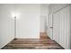 Neutral bedroom with wood-look floors, a floor lamp, and a closet, offering functionality at 4948 Ridgemoor Cir, Palm Harbor, FL 34685