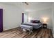 Relaxing bedroom with wood-look flooring, complemented by a bench and soft natural light at 4948 Ridgemoor Cir, Palm Harbor, FL 34685