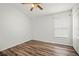 Empty bedroom with wood-look flooring and a ceiling fan, providing a blank canvas at 4948 Ridgemoor Cir, Palm Harbor, FL 34685
