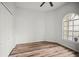 This bedroom offers wood floors, a ceiling fan, a window with natural light and a closet at 4948 Ridgemoor Cir, Palm Harbor, FL 34685