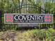Coventry Village at Ridgemoor neighborhood sign amidst lush greenery showing deed restrictions at 4948 Ridgemoor Cir, Palm Harbor, FL 34685