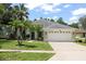 Charming single-story home with a two-car garage, landscaped yard and beautiful palm trees at 4948 Ridgemoor Cir, Palm Harbor, FL 34685