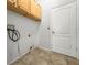 This laundry room features a white door and cabinets above the space for a washer and dryer at 4948 Ridgemoor Cir, Palm Harbor, FL 34685