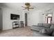 Cozy living room with tile floors, neutral walls, ceiling fan, and a comfortable sectional couch at 4948 Ridgemoor Cir, Palm Harbor, FL 34685