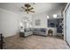 Inviting living room featuring tile flooring, a ceiling fan, and a comfortable sectional sofa at 4948 Ridgemoor Cir, Palm Harbor, FL 34685