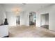 Open-concept living room with tile flooring, a decorative chandelier, and a view into other rooms at 4948 Ridgemoor Cir, Palm Harbor, FL 34685