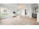 Bright living room features tile flooring, neutral walls, large windows, and chandelier lighting at 4948 Ridgemoor Cir, Palm Harbor, FL 34685